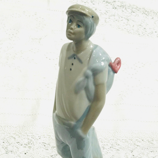 Boy with Cap & Slung Bag – Ceramic Figurine in the Style of Nao | Unmarked Collectible Ornament