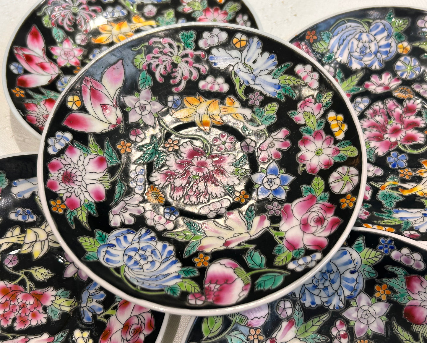 A set of vintage hand painted Chinese saucers