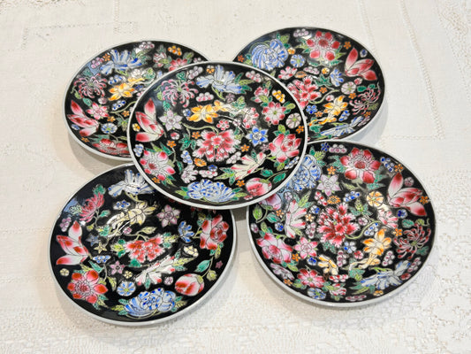 A set of vintage hand painted Chinese saucers