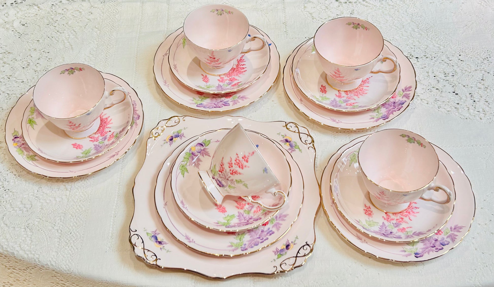 This gorgeous pink tea set is adorned with pink and purple flowers with gold edges. &nbsp;For the vintage china collector or the afternoon tea party enthusiast. You can display it as a beautiful decorative feature in your home or use it to bring a sophisticated touch to your daily tea drinking ritual. Gifts for the Bride, beautiful Wedding China. Very Good Condition. Standard size. &nbsp;  5 Teacups 5 Saucers 5 Tea Plates 1 Cake Plate