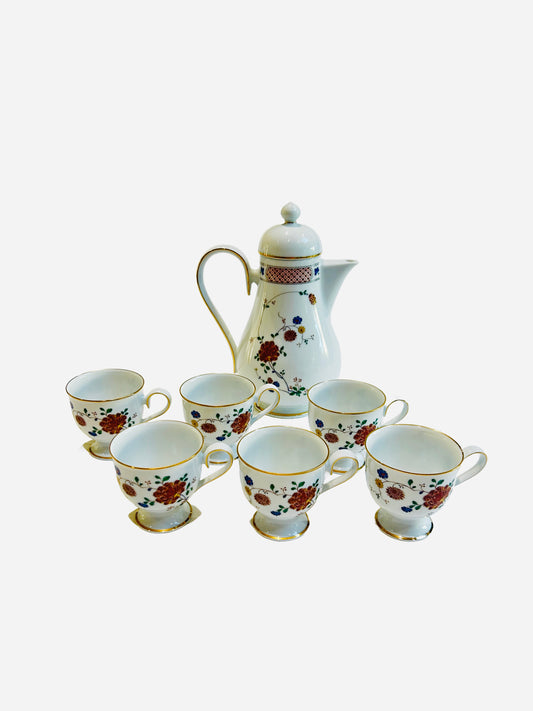 Noritake Nanking - Noritake Nanking coffee set featuring rust lattice borders and delicate blue and yellow floral motifs on fine porcelain. Includes footed cups and matching coffee pot with elegant vintage styling, produced in Japan between 1977–1985.”