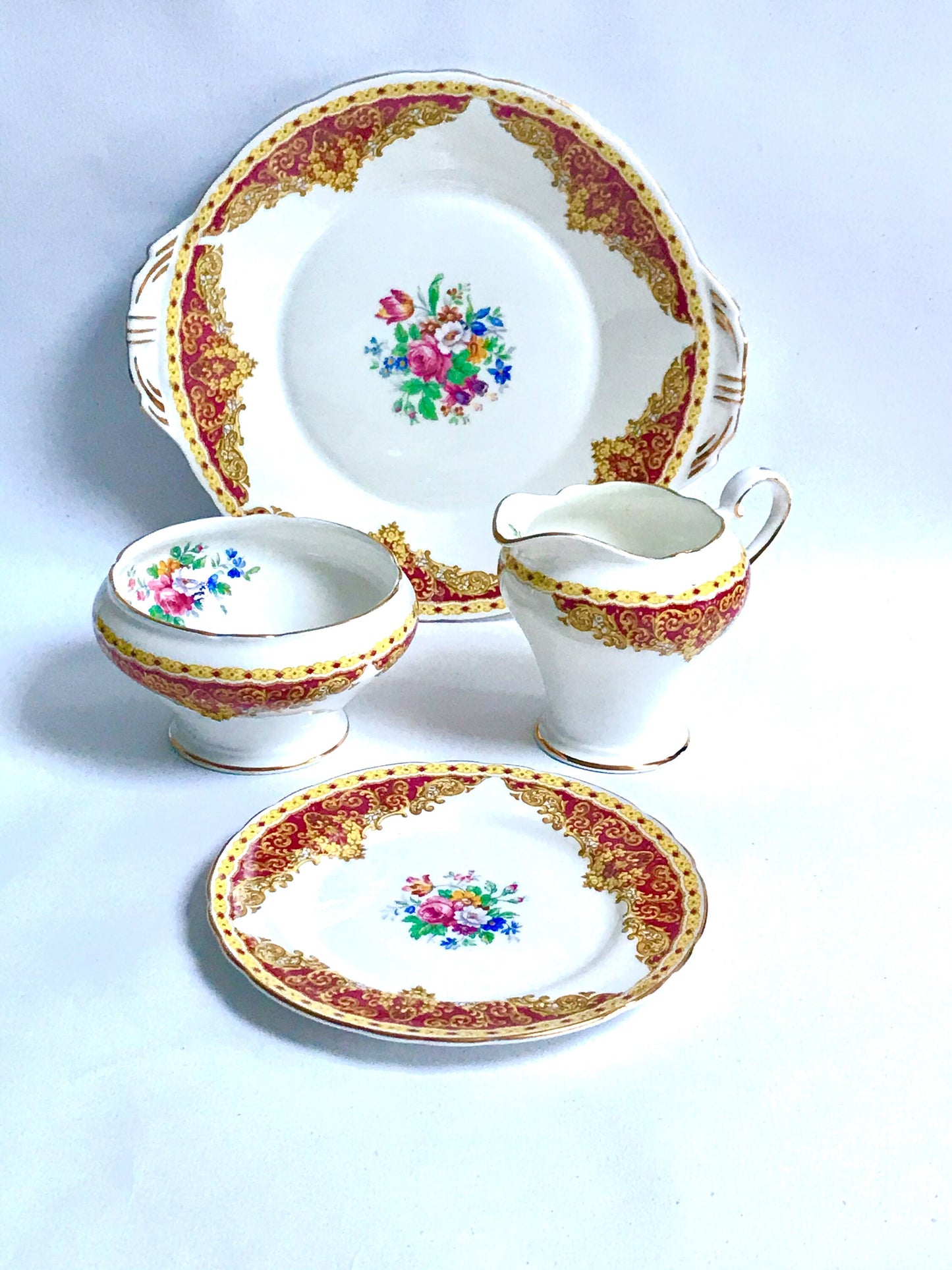 Aynsley 100% quality English Fine Bone China.  Vintage and pre owned in very good condition, replacements and china match.  Afternoon tea, bridal shower, anniversary gifts.   White  and cranberry red base colour decorated with English garden flowers